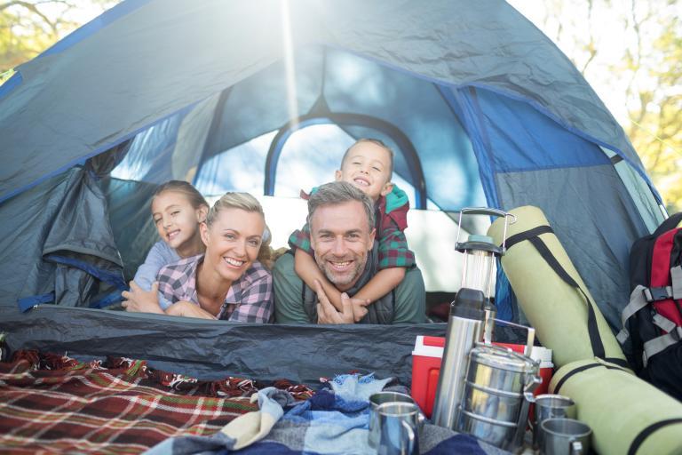 A family hanging out together on a camping trip 