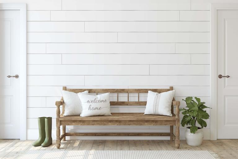 An entryway bench with pillows