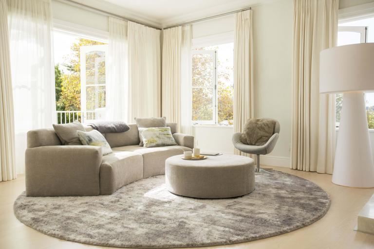 A living room showcasing a sofa, ottoman and chair