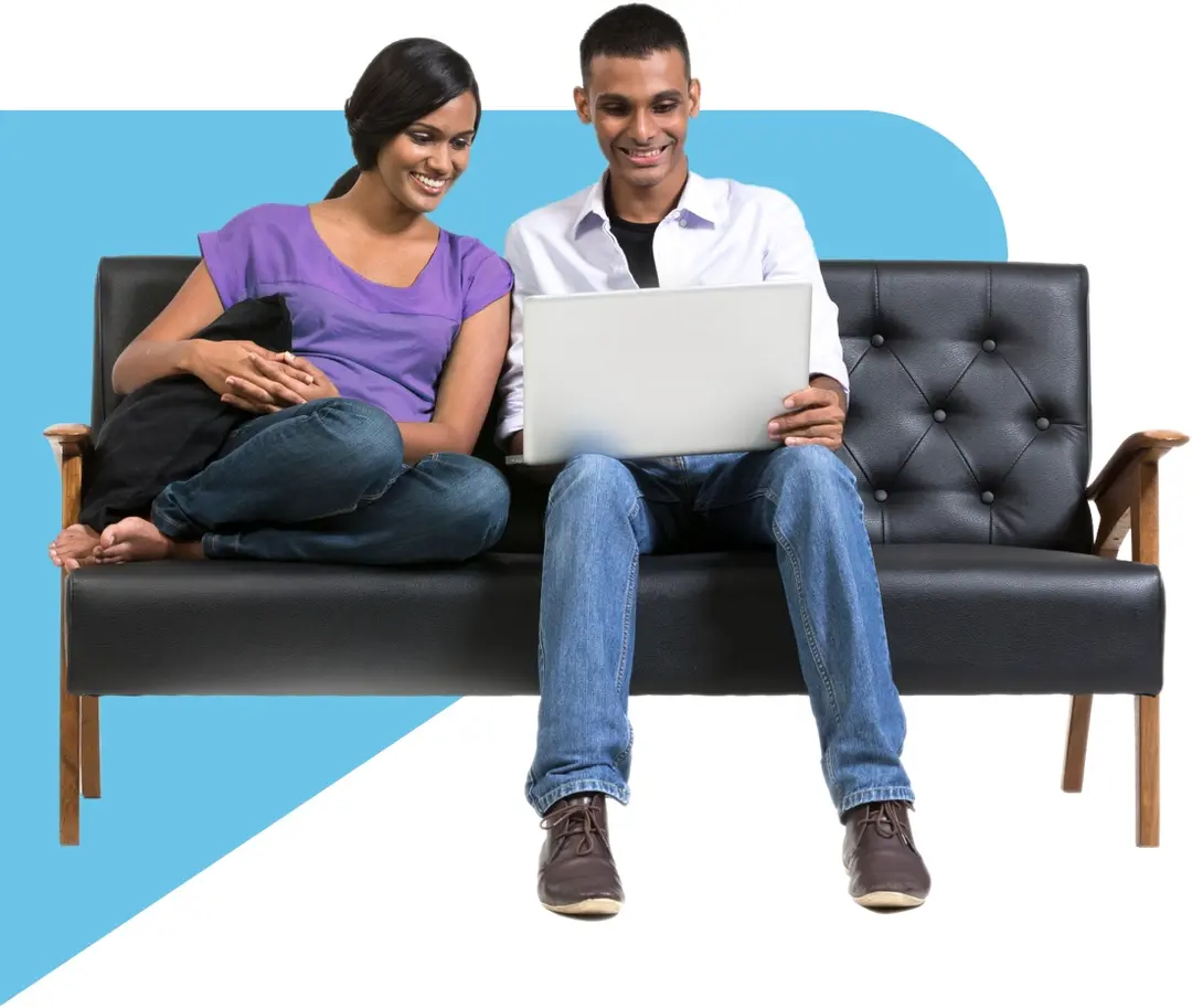 Happy couple shopping online on couch